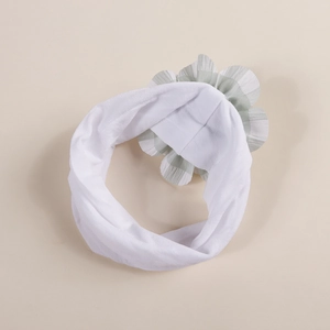 Elastic baby headband in white with a green and white plaid flower decoration for infants