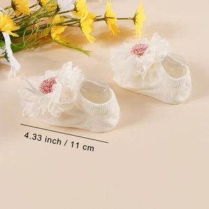 White baby socks with lace flower detail and size measurement 11 cm in length