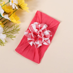 Detail of baby headband featuring watermelon red elastic nylon and plaid fabric flower