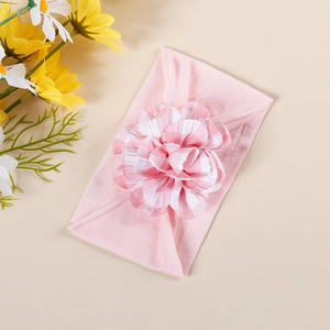 Detail of pink plaid fabric flower on a stretchy nylon headband for newborn babies