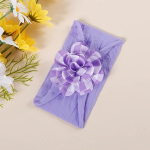 Detail of soft purple checkered flower on a stretchy nylon infant headband for babies