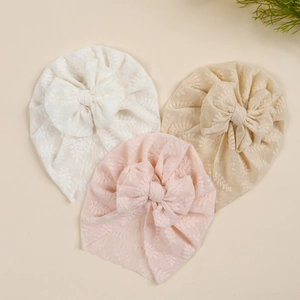 Three-pack set of baby lace turban hats with large bows in white, pink, and beige