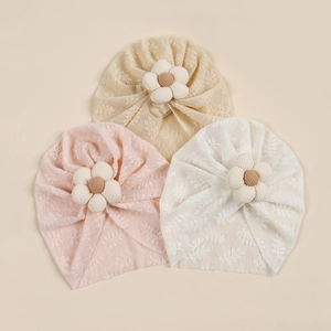 Three-piece set of baby girl lace turban hats with cotton flower accents in neutral tones