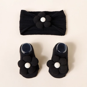 Detail view of baby jacquard nylon headband and socks set with 3D floral accents