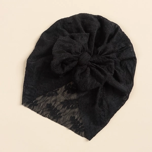 Detail of black lace baby turban featuring a large mesh bow and crochet floral edges