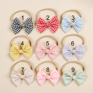 Set of 9 plaid pattern baby headbands with elastic nylon bands and bow detail