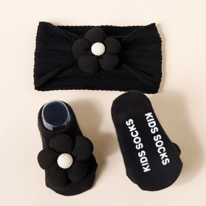 Detail of infant knit headband and socks set with 3D flower and non-slip bottom