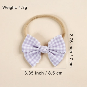 Pink gingham baby headband with elastic nylon band and scalloped bow detail