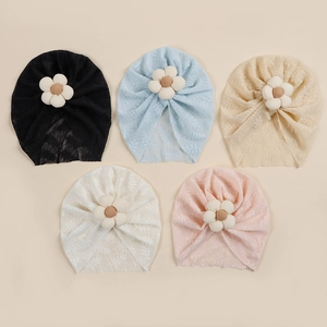 Detail view of five soft lace baby turbans with 3D floral accents in assorted pastel colors