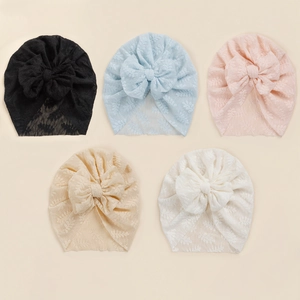 Set of five lace baby beanies with oversized bows in black, blue, pink, beige, and white
