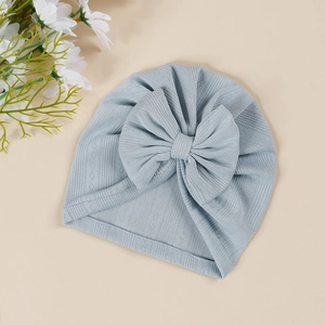Close-up of baby ribbed knit turban hat in light blue with a large decorative bow