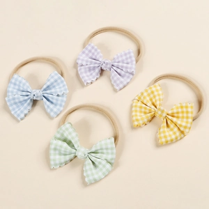 Detailed set of four pastel plaid bow headbands with scalloped edges for babies