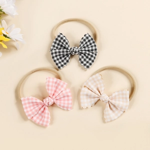 Three-pack of soft nylon baby headbands featuring colorful plaid bows and wave edges