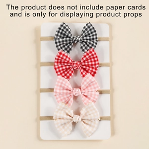 Detail view of four-piece set of infant plaid bow headbands with elastic nylon straps