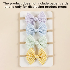 Detail of 4-pack baby gingham bows with scalloped edges on high-elastic nylon headbands