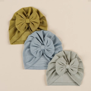 Three-piece baby turban set with large bows in mustard yellow, light blue, and grey