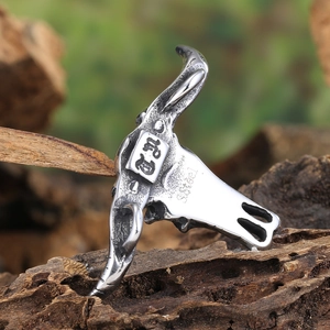 Vintage stainless steel buffalo skull pendant necklace with aged finish on wood