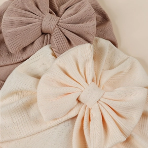 Two-pack newborn baby turban hats with large bows in beige and cream soft knit