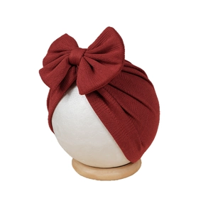 Deep red elastic baby turban hat featuring a large jacquard bow for newborns