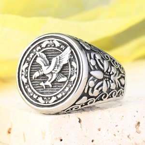 Vintage stainless steel Roman eagle signet ring with floral relief on a stone base
