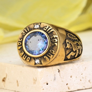 Macro view of vintage gold signet ring with lion relief and blue gemstone detail