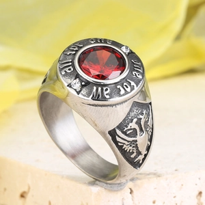 Macro detail of men's retro ring with red gemstone and eagle relief carvings