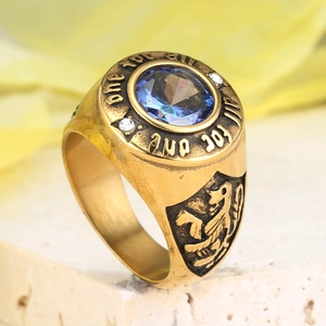 Vintage gold men's ring with deep blue gemstone and lion crest engraving detail