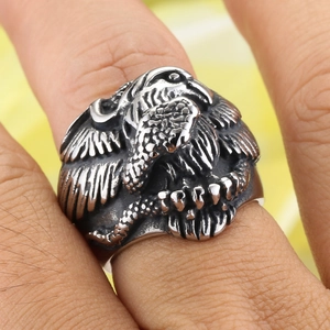 Close-up of eagle and snake relief on a vintage punk stainless steel ring for men