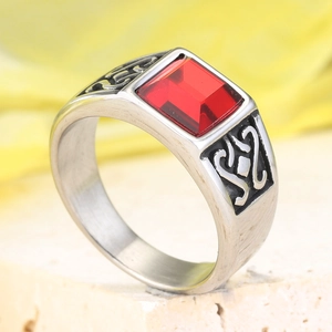 Macro d'une bague rétro en acier inoxydable ornée d'une grande pierre rouge rectangulaire