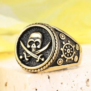 Macro shot of pirate skull ring with crossbones and ship wheel details in punk style
