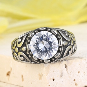 Macro shot of vintage steel ring with large round white zircon and engraved details