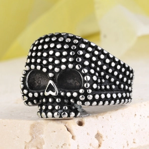 Vintage gothic skull ring in oxidized steel finish on stone pedestal for men and women