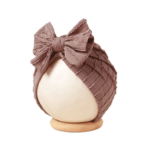 Dusty rose baby turban with large bow knot made of stretchy ribbed jacquard fabric