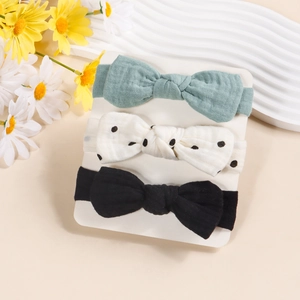 Three-piece set of cotton baby headbands with bows in green, polka dot, and black