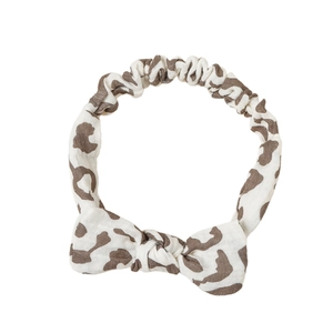 Elastic cotton baby headband with bowknot and leopard print on white background