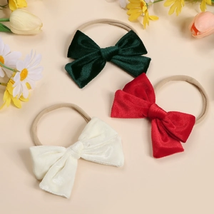 Set of three soft velvet bow headbands for babies in green, red, and cream white colors