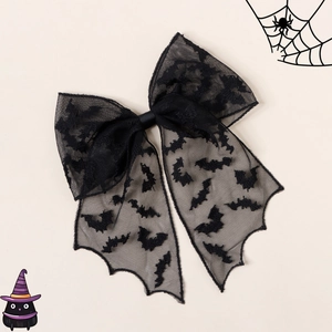 Detail showing black lace Halloween hair bow with bat print and long ribbon tails
