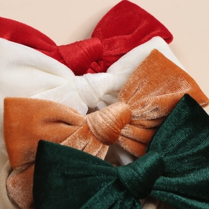 Handmade velvet bow hair ties for girls in vintage red, cream, orange, and green colors