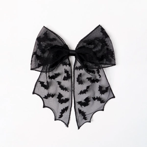 Detailed view of black Halloween bat lace bow hair clip with gothic wing edges