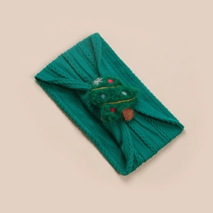 Détail du bandeau tricoté vert foncé pour bébé avec broderie sapin de Noël en peluche