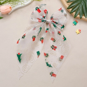 Détail de la pince à cheveux nœud en organza avec motifs de Noël festifs