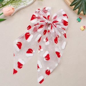 Détail d'un nœud de Noël en tulle avec motifs de bonnet de Noël et paillettes dorées