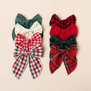 Détail d'un lot de huit nœuds de Noël en coton avec motifs à carreaux et imprimés étoiles