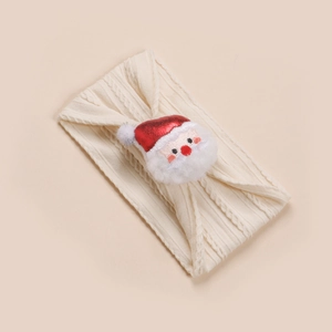 Détail du bandeau en maille crème avec un motif décoratif de Père Noël en relief 3D
