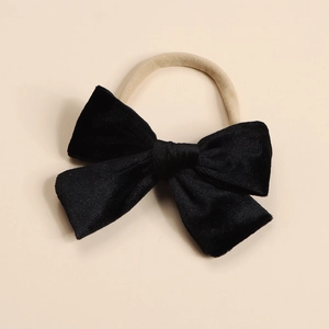 Detail of soft black velvet bow hair tie with high-elastic nylon band for children