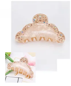 Detailed macro view of champagne acrylic hair claw clip with rhinestones, 9x4cm size