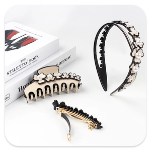 Detailed set of beige and black flower hair accessories with pearls on white background