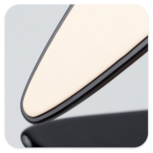 Macro view of beige acetate flower hair claw with matte texture and sleek black edges