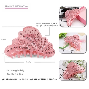 Pink shell-shaped acrylic hair claw clip with rhinestones and product dimensions