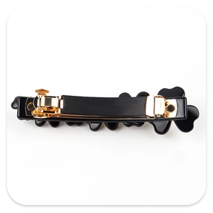 Detailed back view of a black floral hair clip with a sturdy gold metal spring clip